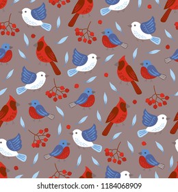 Christmas seamless pattern with birds, rowan berries, leaves and northern cardinals on dark beige background. Perfect for holiday invitations, winter greeting cards, wallpaper and gift paper 