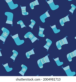 Christmas seamless pattern with blue Christmas socks with snowflakes, specks, pattern