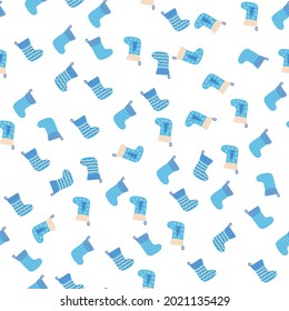 Christmas seamless pattern with blue Christmas socks with snowflakes, specks, pattern