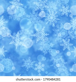 Patrón ininterrumpido de Navidad de copos de nieve borrosos en fondo azul claro
