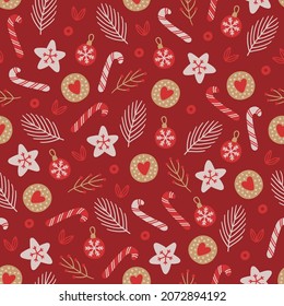 Christmas seamless pattern with candy cane, cookie, ball, fir branches, leaves on dark red background. Scandinavian style. Perfect for winter holidays, xmas wrapping paper, fabric. Vector illustration