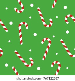 Christmas seamless pattern with candy canes, snow ball on green background. Background for wrapping paper, fabric print, greeting cards. Winter Holiday design.