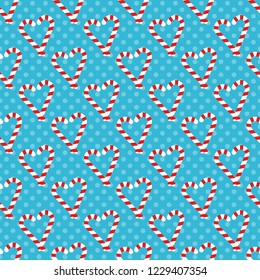 Christmas seamless pattern with candy canesin the shape of a heart and snowflakes. Vector background for wrapping paper, fabric print, greeting cards design