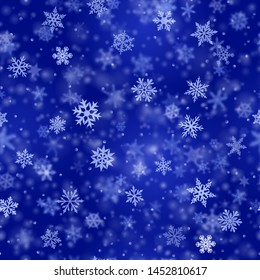 Christmas seamless pattern of complex blurred and clear falling snowflakes in blue colors with bokeh effect