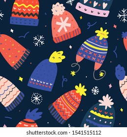 Christmas seamless pattern with cute winter knitted hats decorated with ornaments, beanie bom bom with ear flaps, christmas symbol drawing, hand drawn vector doodle background. Good for wrapping paper