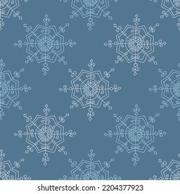 Christmas seamless pattern with doodle snowflakes on a blue background.