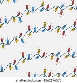 Christmas seamless pattern with garland. Christmas lights background. Seamless pattern with colorful garland of light bulbs.