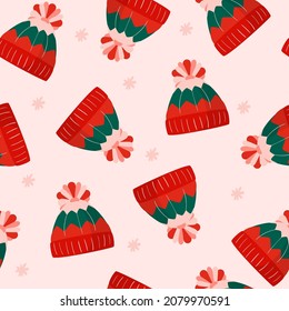 Christmas seamless pattern for greeting cards, wrapping papers. Winter hat in green, pink and red colors. Vector flat illustration