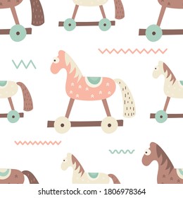 Patrón de Navidad sin fisuras para el diseño de vacaciones y productos de Navidad. Estilo escandinavo. Pequeño juguete de caballo de madera. Ilustración vectorial. El patrón se corta, no hay máscara de recorte.