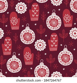 Christmas seamless pattern with leaves, balls, mittens, snowflakes on dark red background. Scandinavian style. Perfect for holiday invitations, winter greeting cards, wallpaper and gift paper 