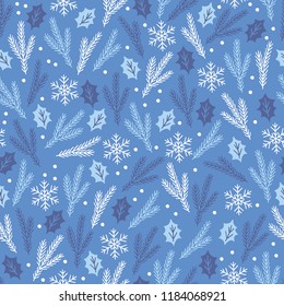 Christmas seamless pattern with leaves, snowflakes and fir branches on blue background. Perfect for holiday invitations, winter greeting cards, wallpaper and gift paper 