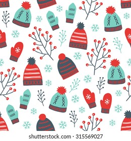 Christmas seamless pattern with mittens, hats, branches and snowflakes. Perfect for wallpaper, gift paper, pattern fills, textile, Christmas and New Year greetings cards