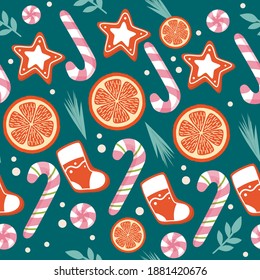 Christmas seamless pattern. New Year's elements on a green background. Candy oranges lollipop cane leaves and fir branches