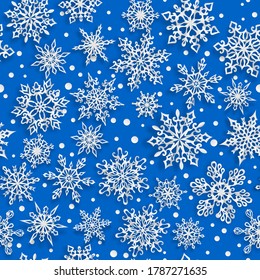 Christmas seamless pattern of paper snowflakes with soft shadows on blue background
