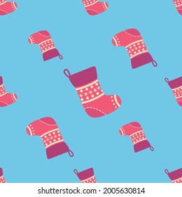 Christmas seamless pattern with red Christmas socks with snowflakes, specks