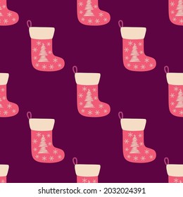 Christmas seamless pattern with red christmas socks with hand drawn christmas tree.