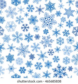 Christmas seamless pattern of small and big snowflakes, blue on white