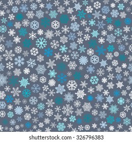 Christmas seamless pattern of small snowflakes, white and blue on gray