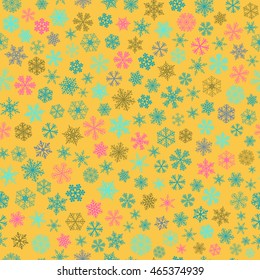 Christmas seamless pattern of small snowflakes, light blue and pink on yellow