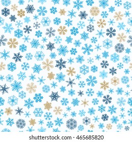 Christmas seamless pattern of small snowflakes, brown and blue on white background
