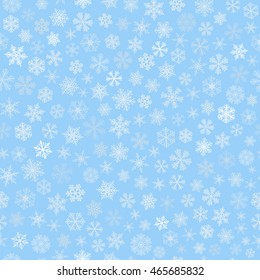 Christmas seamless pattern of small snowflakes, white on light blue