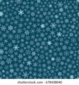 Christmas seamless pattern of small snowflakes, white on blue