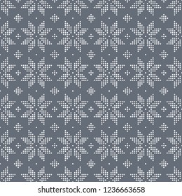 Christmas seamless pattern of snowflakes big classic knitted pattern of small circles of white dots on a dark grey background.
