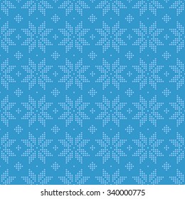Christmas seamless pattern of snowflakes big classic knitted pattern of small dots circles in blue.