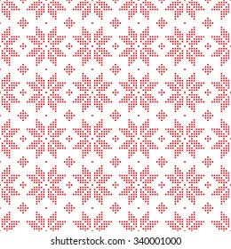 Christmas seamless pattern of snowflakes big classic knitted pattern of small dots of red circles on a white background.