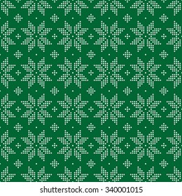 Christmas seamless pattern of snowflakes big classic knitted pattern of small circles of white dots on a green background.
