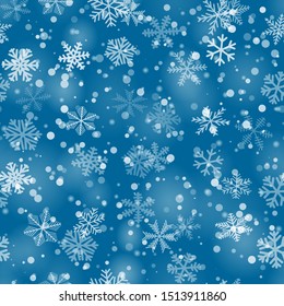 Christmas seamless pattern of snowflakes of different shapes, sizes and transparency in light blue colors