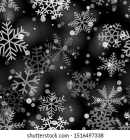 Christmas seamless pattern of snowflakes of different shapes, sizes and transparency in gray and black colors