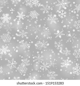 Christmas seamless pattern of snowflakes of different shapes, sizes and transparency in gray colors