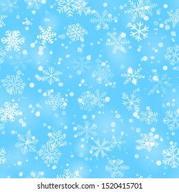 Christmas seamless pattern of snowflakes of different shapes, sizes and transparency in light blue colors