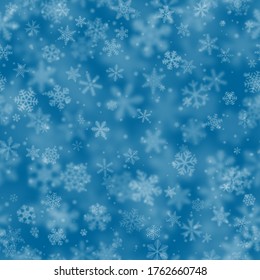 Christmas seamless pattern of snowflakes of different shapes, sizes, blur and transparency on light blue background