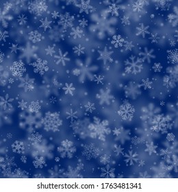 Christmas seamless pattern of snowflakes of different shapes, sizes, blur and transparency on blue background
