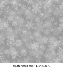 Christmas seamless pattern of snowflakes of different shapes, sizes, blur and transparency on gray background