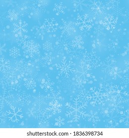 Christmas seamless pattern of snowflakes of different shapes, sizes and transparency, on light blue background