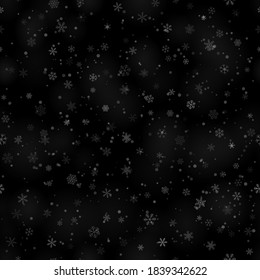 Patrón ininterrumpido de Navidad de copos de nieve de diferentes formas, tamaños y transparencia, sobre fondo negro