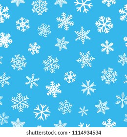 Christmas seamless pattern of snowflakes, white on light blue background