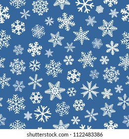 Christmas seamless pattern of snowflakes, white on light blue background