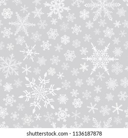 Christmas seamless pattern of snowflakes, white on gray background.