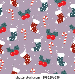 Christmas seamless pattern with sock, candycane, holly and snow on pink background.Happy New Year background.Christmas pattern winter background. 