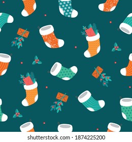 Christmas seamless pattern with socks and mistletoe. Vector, trending colors.