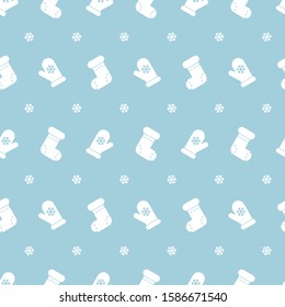 Christmas seamless pattern with socks and mittens on blue background. Vector illustration. For web design, wallpaper, wrapping paper, scrapbooking, for printing on clothes, textile, cups, package.