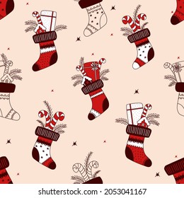 Christmas seamless pattern. Christmas stocking with gifts and chocolates. Vector illustration. Hand drawing color and sketch for decor, design, print, packaging, wallpaper and textile