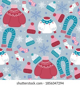 Christmas seamless pattern with sweater, woolen hat, snowflakes, socks, scarf on grey background. Scandinavian style. Perfect for holiday invitations, winter greeting cards, wallpaper and gift paper 
