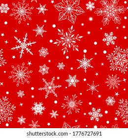 Christmas seamless pattern with various complex big and small snowflakes, white on red background
