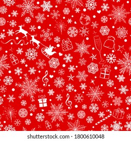 Christmas seamless pattern of various snowflakes and holiday symbols, white on red background