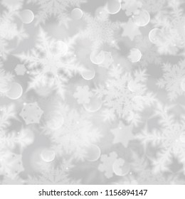 Christmas seamless pattern with white blurred snowflakes, glare and sparkles on gray background